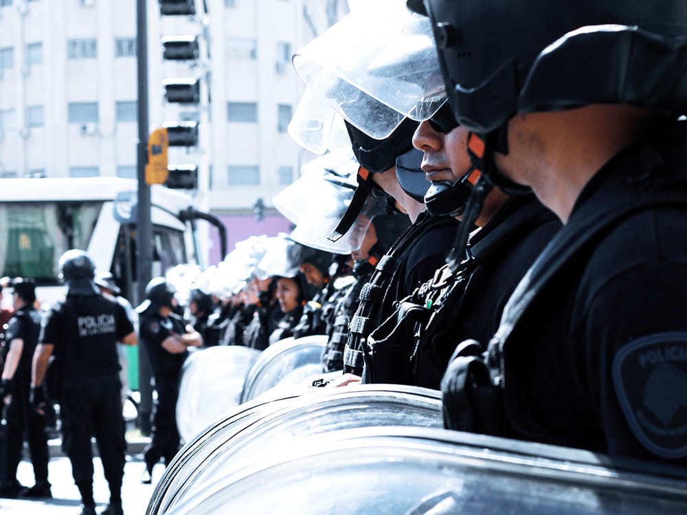 police officer takes riot shields